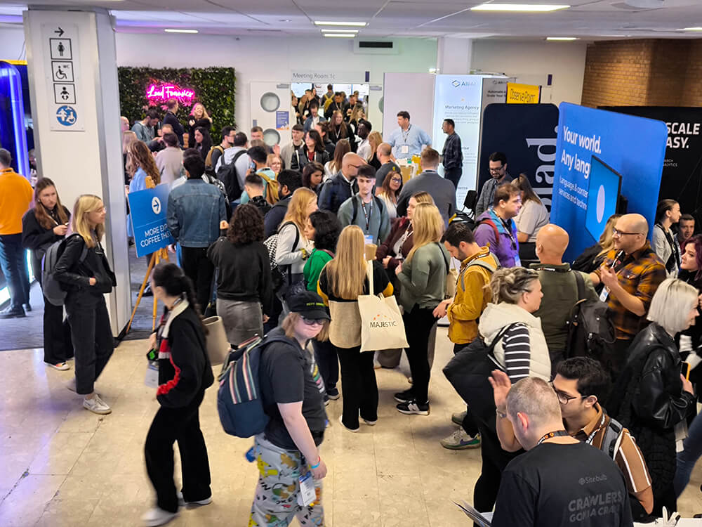 a conference area completely filled with people at BrightonSEO 2024